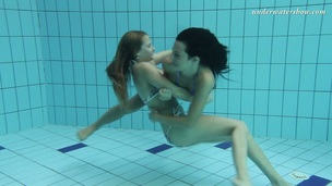 2 tempting mermaids caressing each other underwater